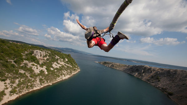 A bungee jumper launches into a jump